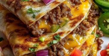 Crispy ground beef and cheese quesadillas sliced into wedges, served with sour cream, guacamole and salsa on the side.