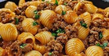 Creamy beef and shells pasta served in a bowl with ground beef, tender shell pasta, tomato cream sauce and melted cheese.