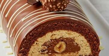 Ferrero Rocher chocolate hazelnut cake roll with cocoa sponge, Nutella cream filling, chocolate ganache and hazelnut decoration.