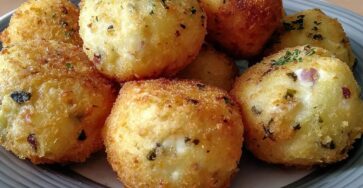 Golden crispy potato balls filled with cream cheese, freshly fried and served hot with a crunchy breadcrumb coating.