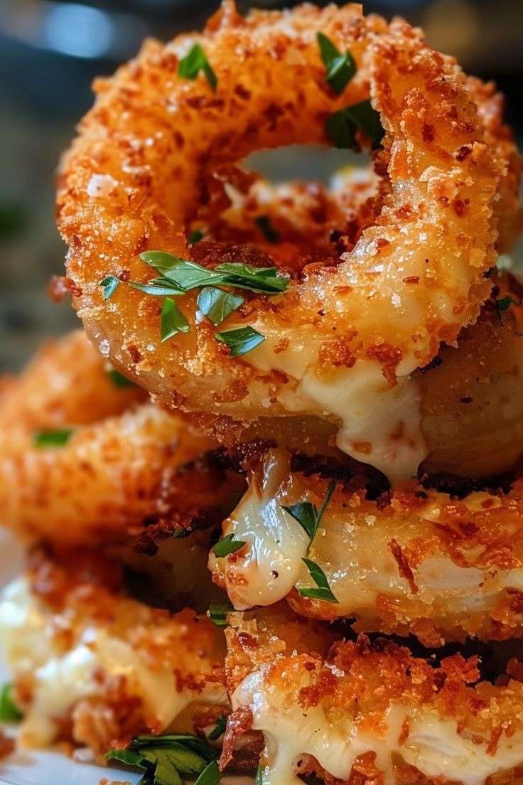 Crispy cheesy stuffed mozzarella onion rings with a golden coating and gooey center.