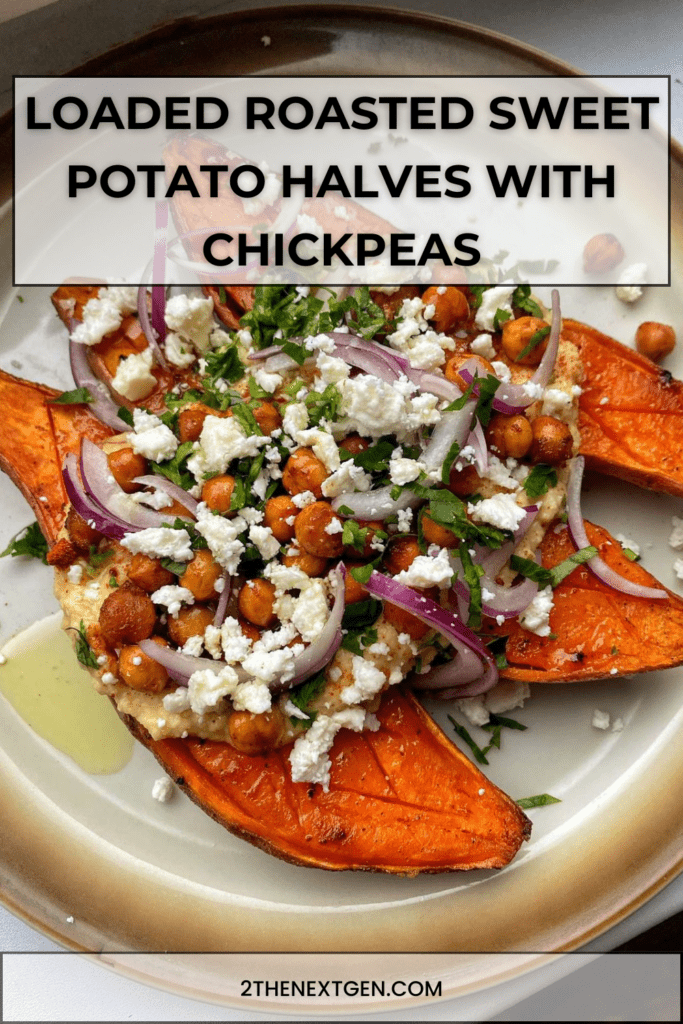 loaded roasted sweet potato halves topped with crispy spiced chickpeas, crumbled feta cheese, red onion and fresh parsley on a baking tray.