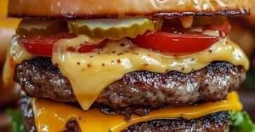 Classic homemade double cheeseburger with melted American cheese, special sauce, lettuce, tomato, onion and pickles on a sesame seed bun.