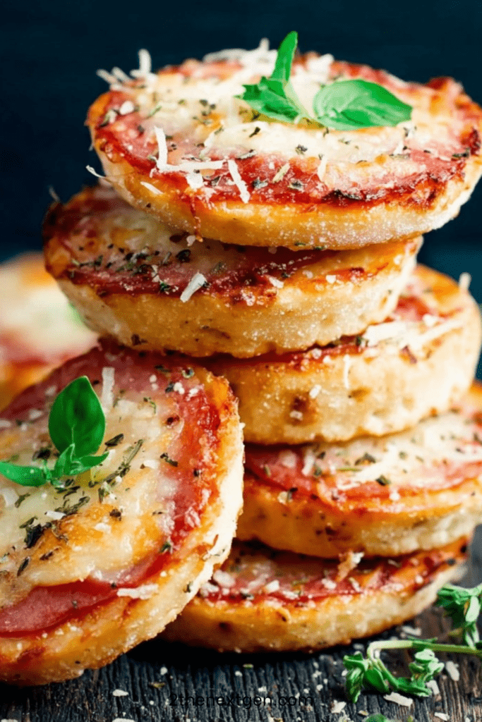 Easy mini crispy pizza bites topped with melted mozzarella, salami slices, tomato sauce, and fresh basil leaves