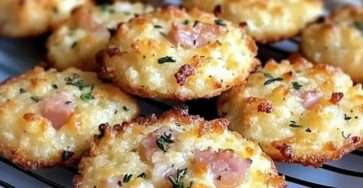 Golden savory Parmesan and ham cookies on a baking tray, crisp edges with a soft cheesy interior, garnished with dried herbs and served warm.