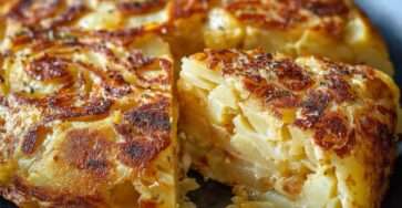 Golden Spanish tapas-style tortilla made with thinly sliced potatoes and eggs, cut into wedges on a plate, with a tender fluffy center and lightly browned top.