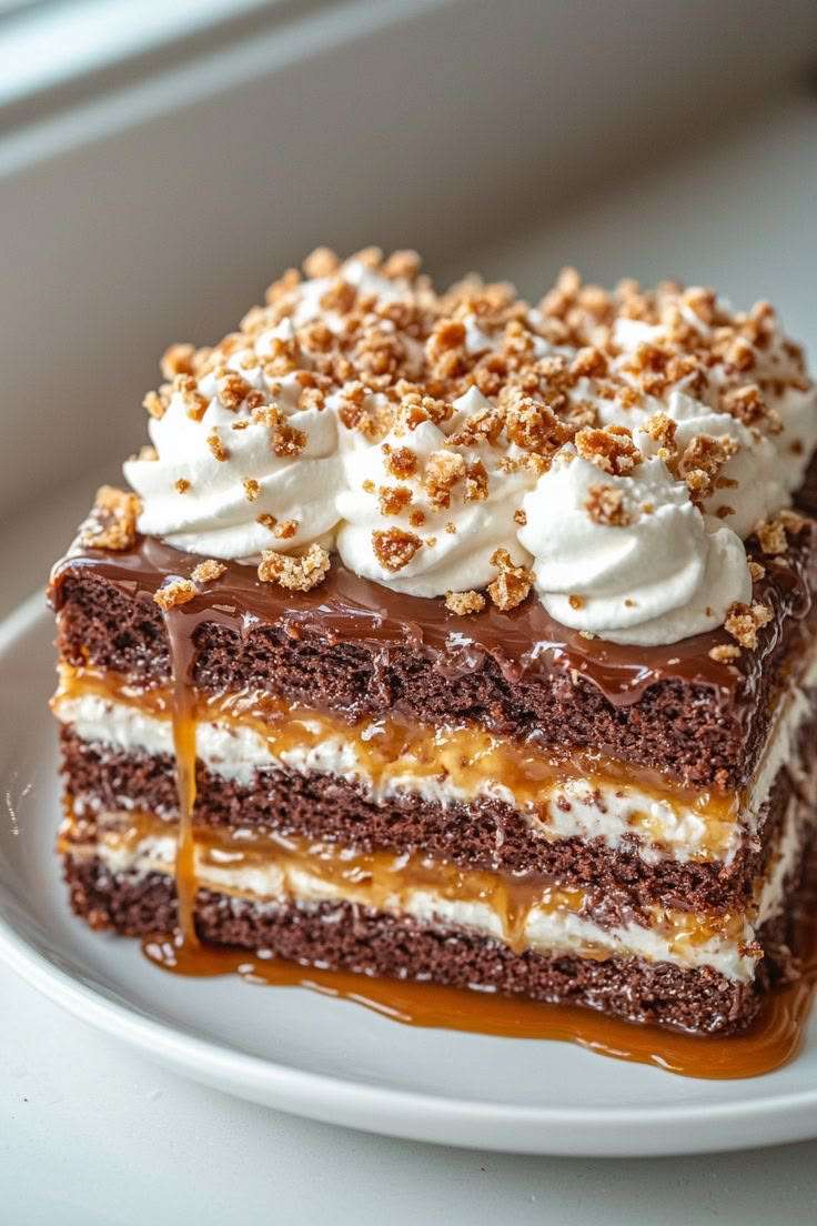 Chocolate caramel layer cake with three chocolate sponge layers, mascarpone cream filling, caramel drizzle, glossy ganache, and whipped cream decoration.