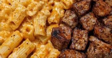 Creamy cheesy rigatoni pasta served with tender garlic butter steak bites, parmesan, parsley, and a rich homemade cheese sauce.
