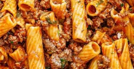 Beef rigatoni with rich tomato sauce served with grated parmesan, fresh parsley, black pepper, and tender ground beef sauce.