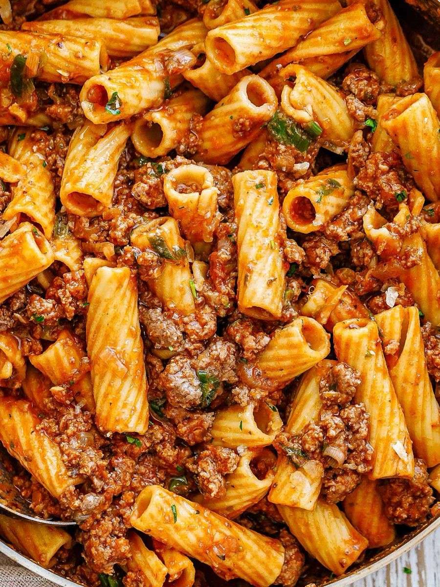 Beef rigatoni with rich tomato sauce served with grated parmesan, fresh parsley, black pepper, and tender ground beef sauce.