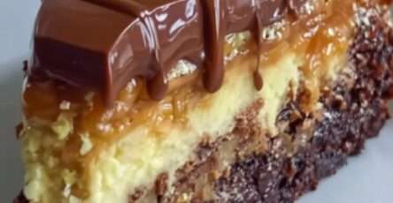 Chocolate caramel cheesecake brownie cake with a fudgy brownie base, creamy cheesecake layer, caramel topping, glossy ganache, nuts, and coconut.