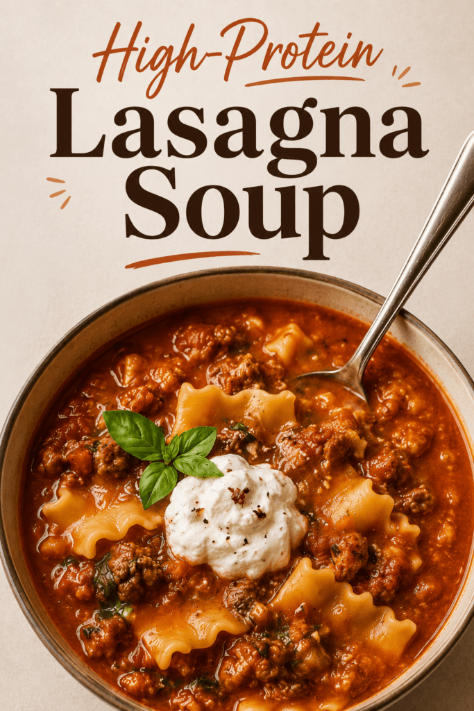 Close-up of high-protein lasagna soup in a bowl with rich tomato broth, tender pasta pieces, lean ground meat, melted mozzarella, cottage cheese, parmesan, and fresh basil.