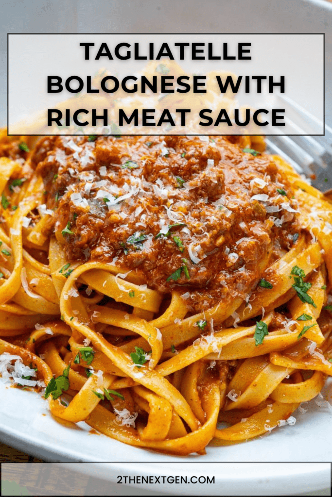 Tagliatelle Bolognese served with rich ground beef tomato sauce, grated parmesan, chopped parsley, and black pepper on top.