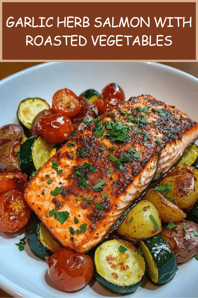 Garlic herb salmon fillets baked over roasted baby potatoes, zucchini, cherry tomatoes, lemon, garlic, parsley, and herbs.