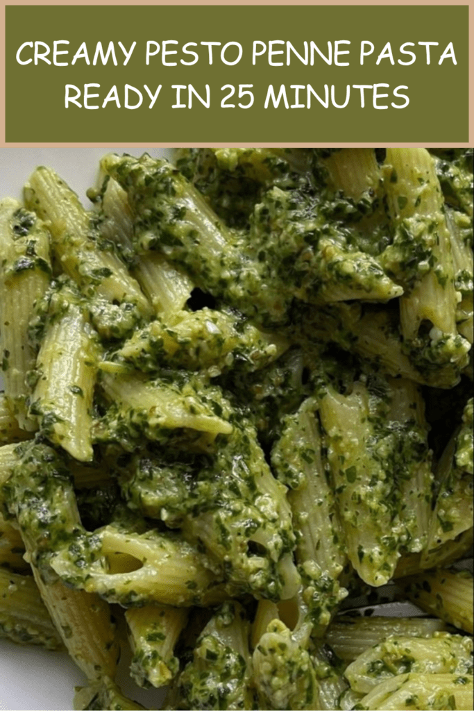 Creamy pesto penne pasta served in a bowl with green basil sauce, grated parmesan, black pepper, fresh basil leaves, and a rich creamy texture.