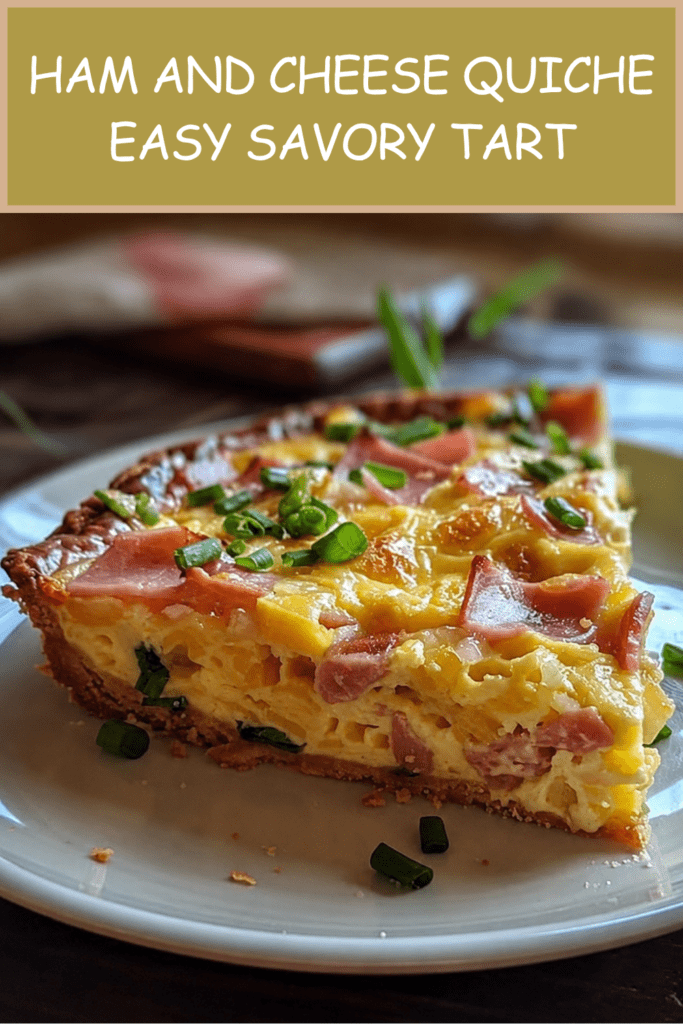 A golden ham and cheese quiche sliced on a plate with creamy egg filling, diced ham, melted cheese, fresh chives, flaky crust, and black pepper on top.