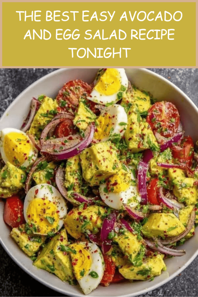 A clear glass bowl filled with a colorful avocado and egg salad, showcasing hard-boiled egg quarters, diced green avocado, red onion slices, and cherry tomatoes.