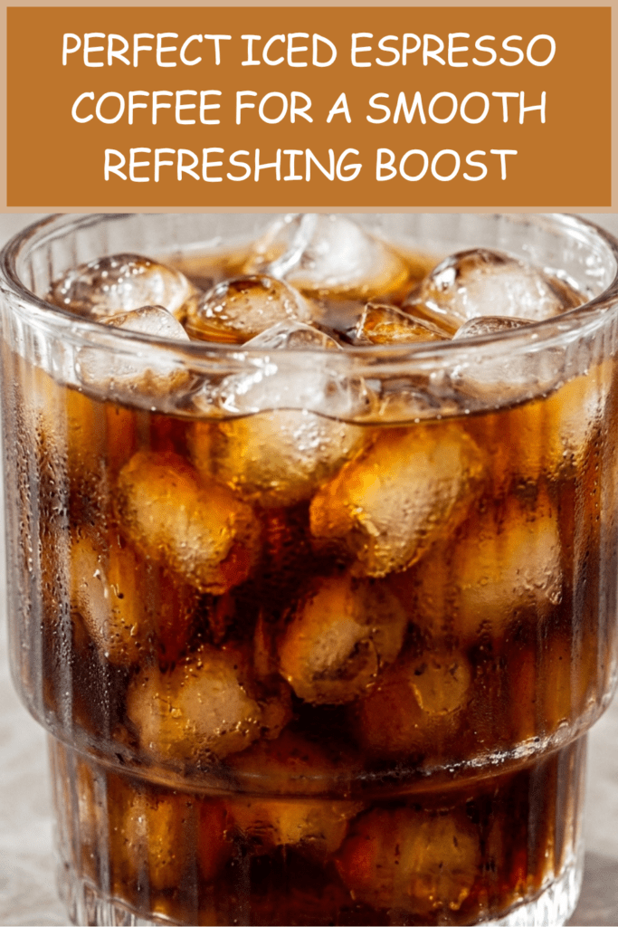 A ribbed glass tumbler filled with bullet-shaped ice cubes and freshly poured iced espresso coffee. The dark coffee cascades over the ice, creating beautiful swirling patterns in a clear aesthetic glass, served as a refreshing homemade cold coffee beverage.