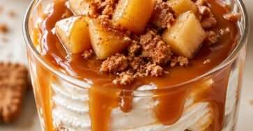 Caramel apple speculoos dessert cups layered with mascarpone cream, caramelized cinnamon apples, crushed Biscoff cookies, and caramel sauce.