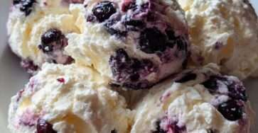 Lemon blueberry cottage cheese ice cream bites made with Greek yogurt, honey, vanilla, and fresh blueberries, served frozen with lemon zest.