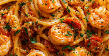 Creamy garlic shrimp spaghetti with cherry tomatoes, Parmesan cheese, parsley, lemon, and tender shrimp in a rich garlic cream sauce.