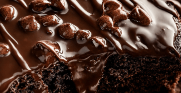 Double chocolate ganache cake with a moist cocoa crumb, melted chocolate chips, glossy dark chocolate ganache, and extra chocolate chips on top.
