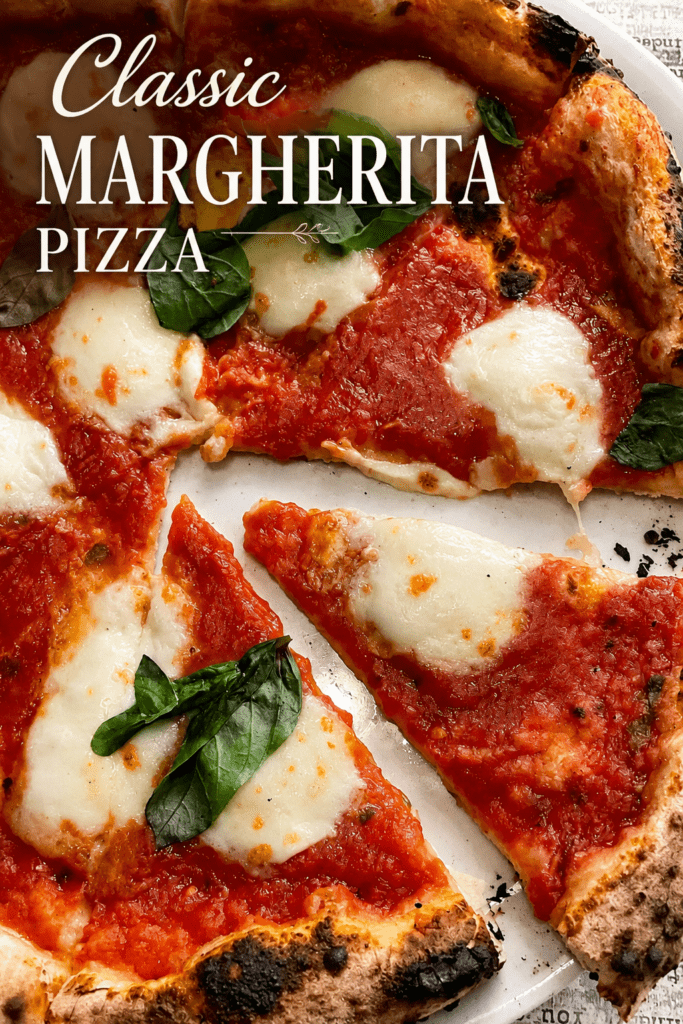 Homemade Margherita pizza with a golden puffed crust, fresh tomato sauce, melted mozzarella, basil leaves, olive oil, and cracked black pepper.