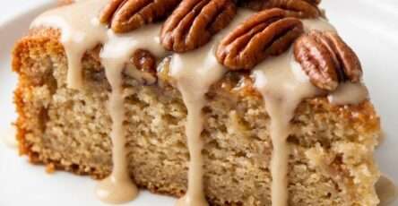 Rich sugar-free gooey butter pecan cake slice with pecan topping, soft buttery center, golden crumb, and sugar-free drizzle on top.