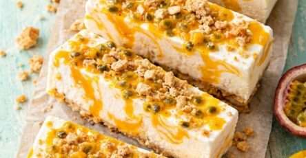 Mango passion fruit frozen yogurt bars cut into squares with creamy yogurt, mango swirls, passion fruit pulp and crunchy granola topping.
