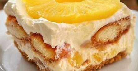 Creamy no-bake pineapple mascarpone dessert layered with soaked ladyfingers, vanilla mascarpone cream, and juicy pineapple pieces in elegant glasses.