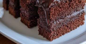Sugar-free frosted fudge cakes cut into neat rectangles with soft chocolate sponge layers, creamy chocolate filling, and glossy fudge topping.