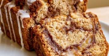 Sugar-free Amish mock apple fritter bread loaf sliced with cinnamon mock apple swirl, white glaze drizzle, and soft low-carb crumb.